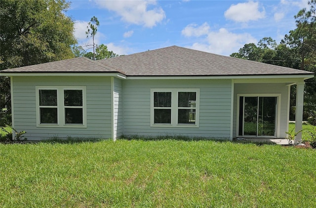 back of property featuring a yard