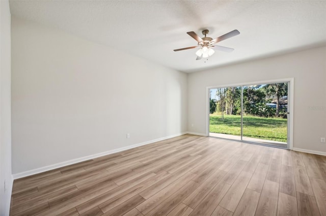 unfurnished room with ceiling fan, light hardwood / wood-style flooring, and a textured ceiling