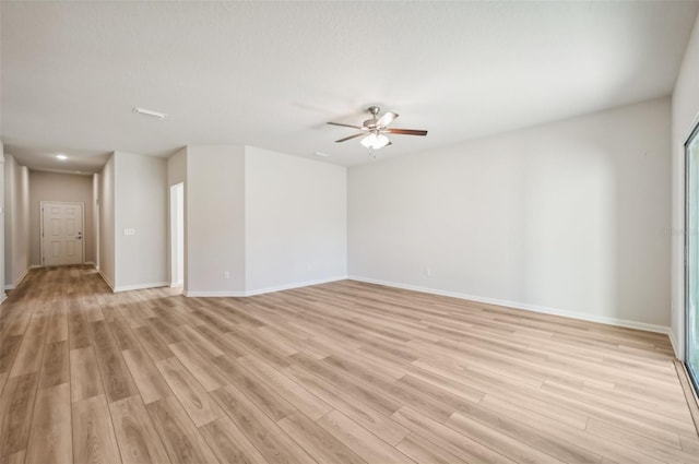 empty room with ceiling fan and light wood-type flooring