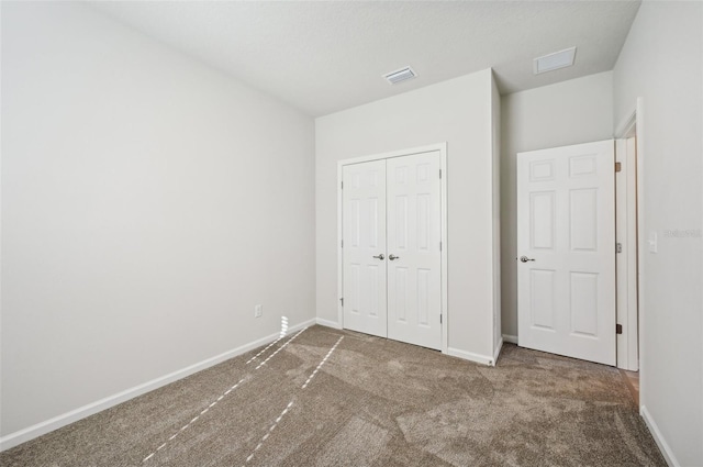 unfurnished bedroom featuring a closet and carpet flooring