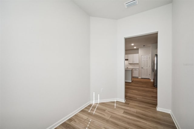 unfurnished room with light wood-type flooring