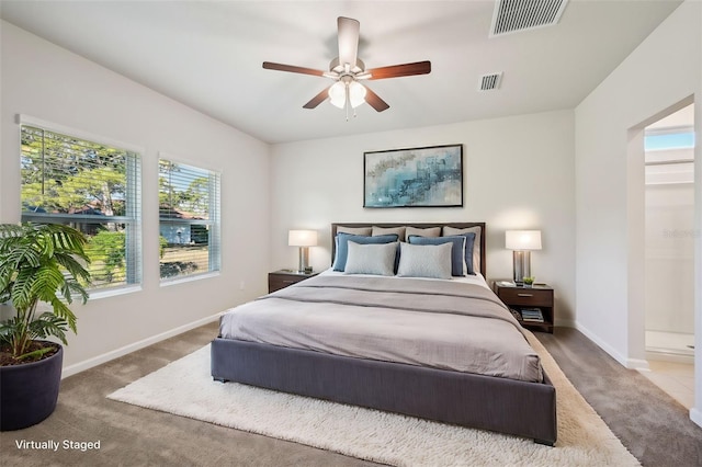 bedroom with ensuite bath, ceiling fan, and carpet flooring