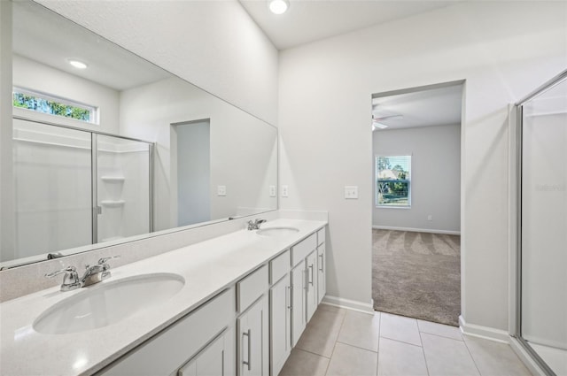 bathroom with tile patterned flooring, vanity, plenty of natural light, and a shower with door