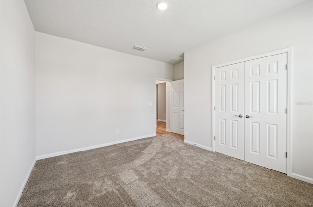 unfurnished bedroom with carpet floors and a closet