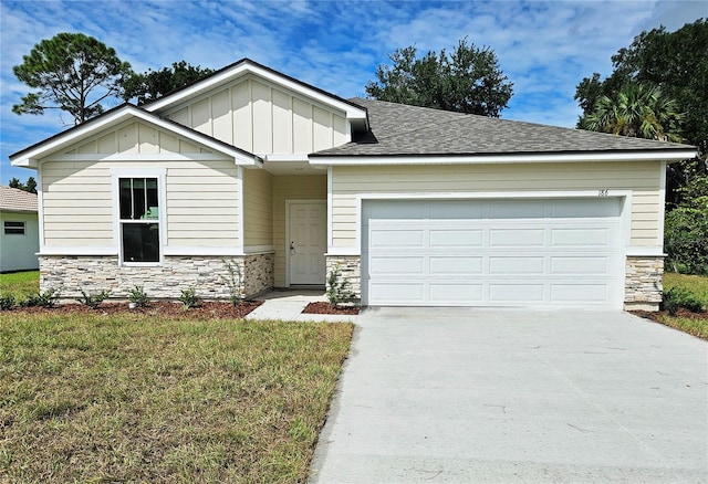 view of front of house featuring a front lawn and a garage