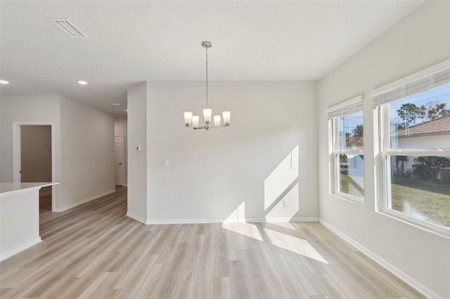 interior space with light wood-type flooring and a chandelier