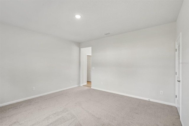 unfurnished room featuring carpet