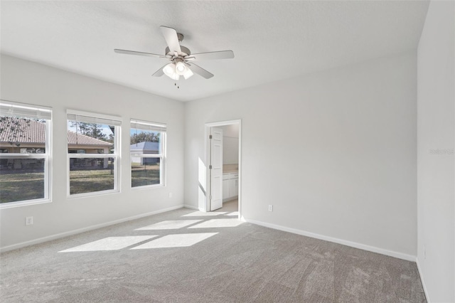 spare room with ceiling fan and light colored carpet