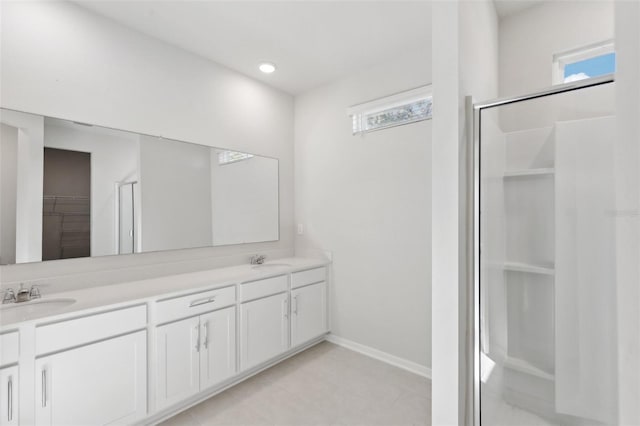 bathroom featuring vanity and a shower with door