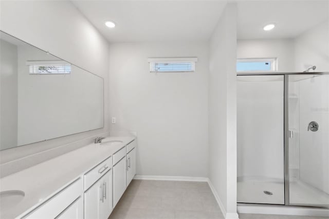 bathroom featuring a shower with door and vanity