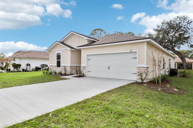 view of front facade with a garage, central AC, and a front lawn