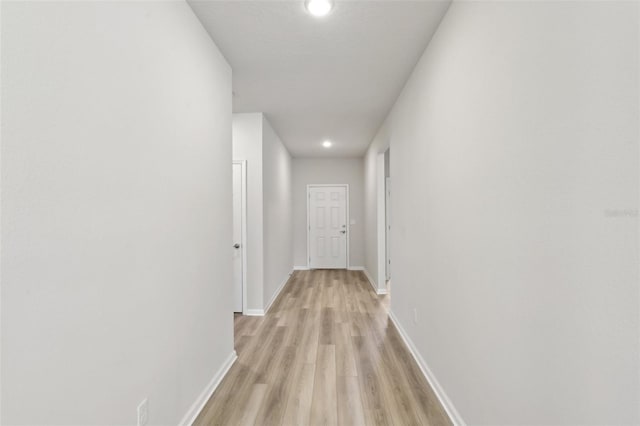 hallway with light hardwood / wood-style flooring