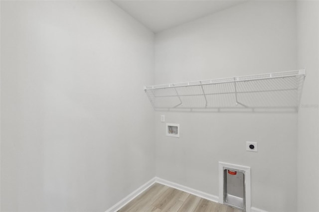 clothes washing area with light wood-type flooring, washer hookup, and electric dryer hookup