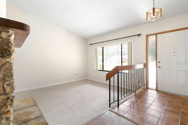 foyer entrance featuring a textured ceiling and tile patterned flooring