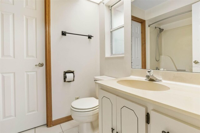 bathroom with vanity, toilet, and tile patterned floors