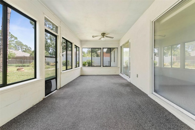 unfurnished sunroom featuring ceiling fan