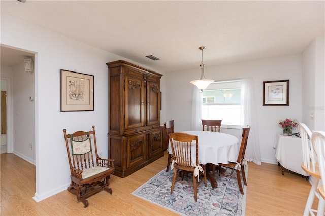 dining area featuring light wood-type flooring