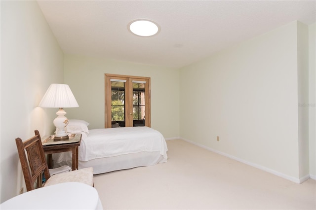 bedroom featuring carpet and french doors