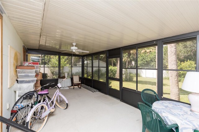 sunroom with plenty of natural light, ceiling fan, and lofted ceiling