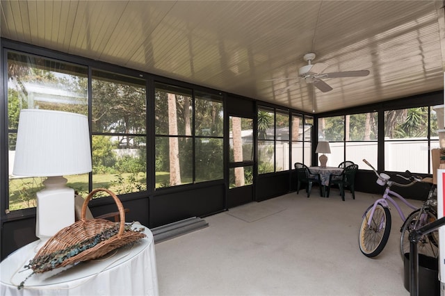 sunroom / solarium with ceiling fan, lofted ceiling, and a wealth of natural light