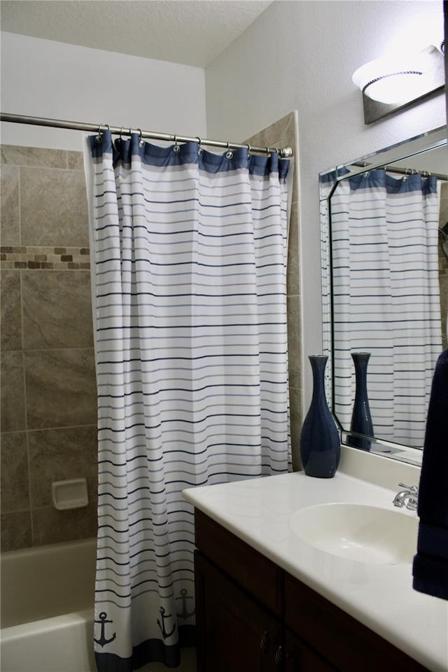 bathroom with shower / bath combo and vanity