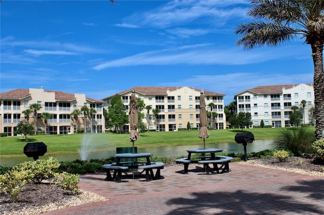 view of community featuring a water view and a lawn