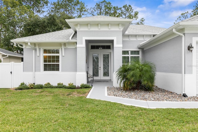 view of exterior entry featuring a lawn