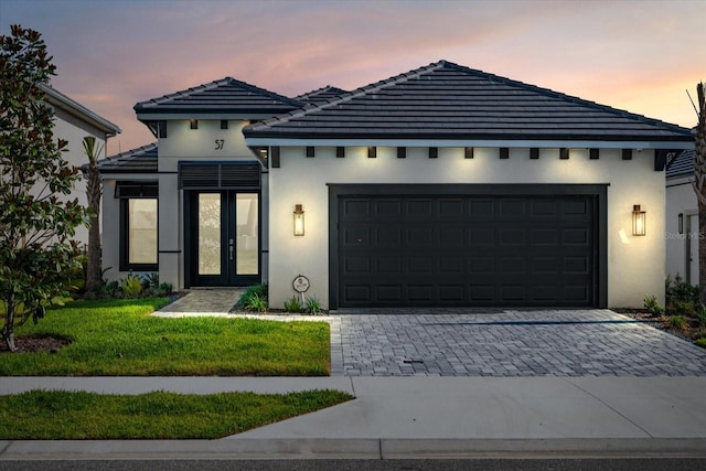 view of front of property featuring a garage and a yard