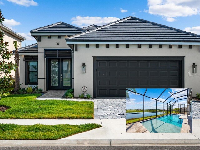 view of front of home with a garage and a front yard