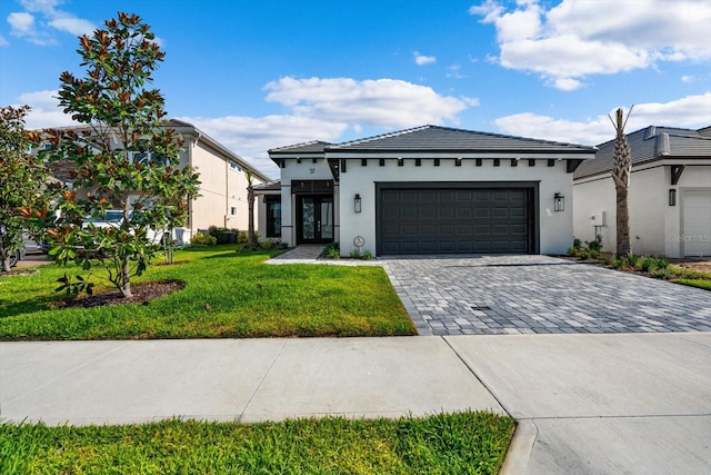 view of front of property featuring a garage and a front yard