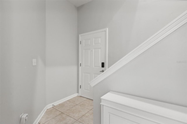 stairs featuring baseboards and tile patterned floors