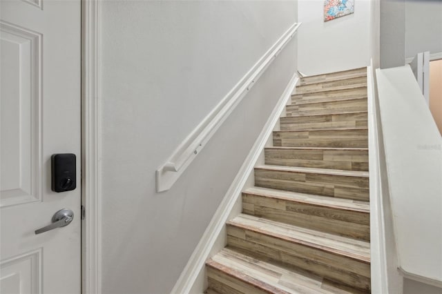 stairway featuring wood finished floors