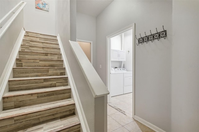 staircase featuring separate washer and dryer and tile patterned floors