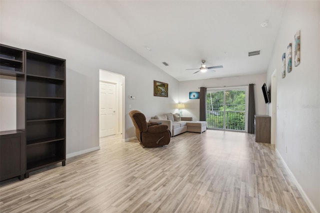 living room featuring vaulted ceiling, light wood-type flooring, visible vents, and baseboards