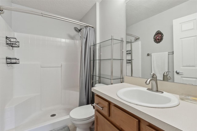 bathroom featuring curtained shower, toilet, a textured ceiling, and vanity