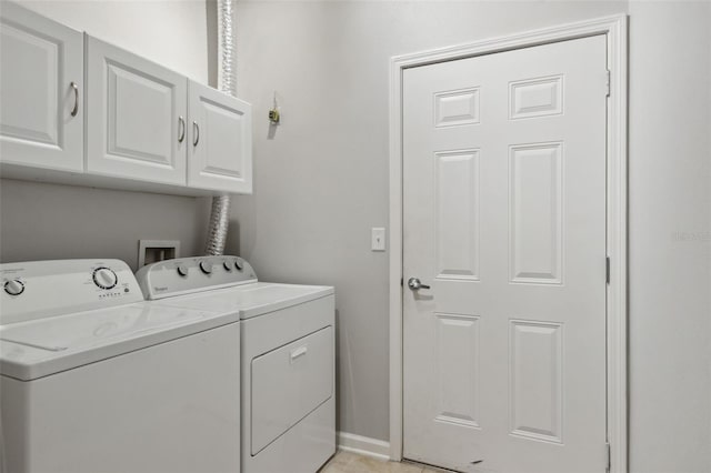 washroom with cabinet space and washer and clothes dryer