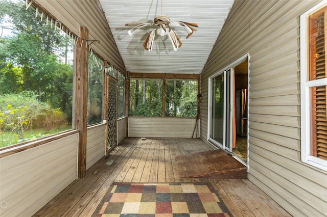 unfurnished sunroom featuring lofted ceiling and ceiling fan