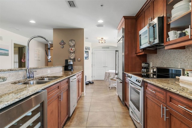 kitchen featuring light tile patterned flooring, wine cooler, stainless steel appliances, and backsplash