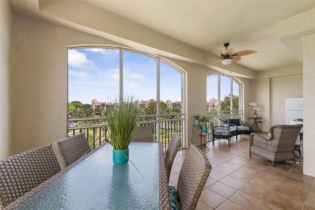 sunroom featuring ceiling fan