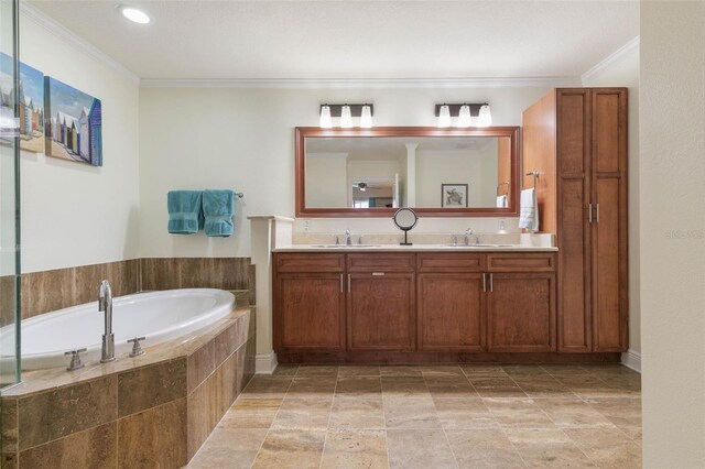 bathroom featuring dual bowl vanity, tiled tub, crown molding, and tile patterned floors