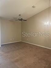 spare room with vaulted ceiling and ceiling fan