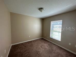 empty room with dark carpet