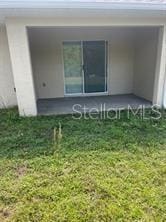 rear view of house featuring a yard