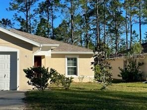 view of property exterior featuring a garage and a lawn