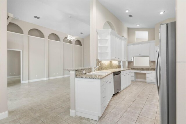 kitchen with sink, light tile patterned floors, ceiling fan, white cabinetry, and appliances with stainless steel finishes