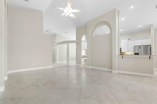 spare room featuring high vaulted ceiling, ceiling fan, and light tile patterned floors