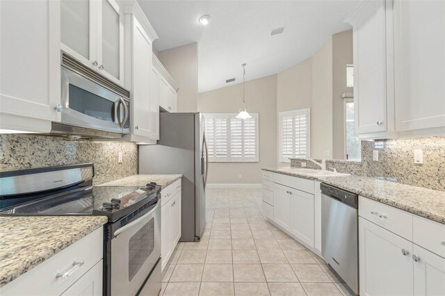 kitchen featuring white cabinetry, appliances with stainless steel finishes, lofted ceiling, and sink