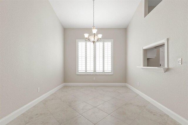 spare room with an inviting chandelier