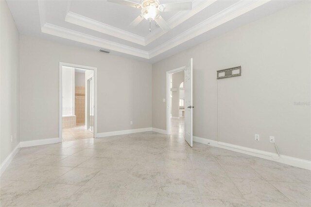 unfurnished room with ceiling fan, ornamental molding, and a raised ceiling