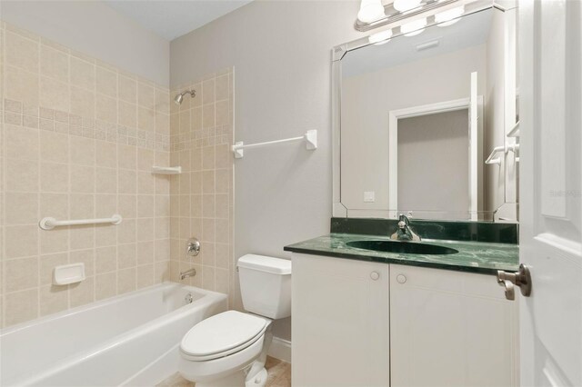 full bathroom featuring vanity, toilet, and tiled shower / bath